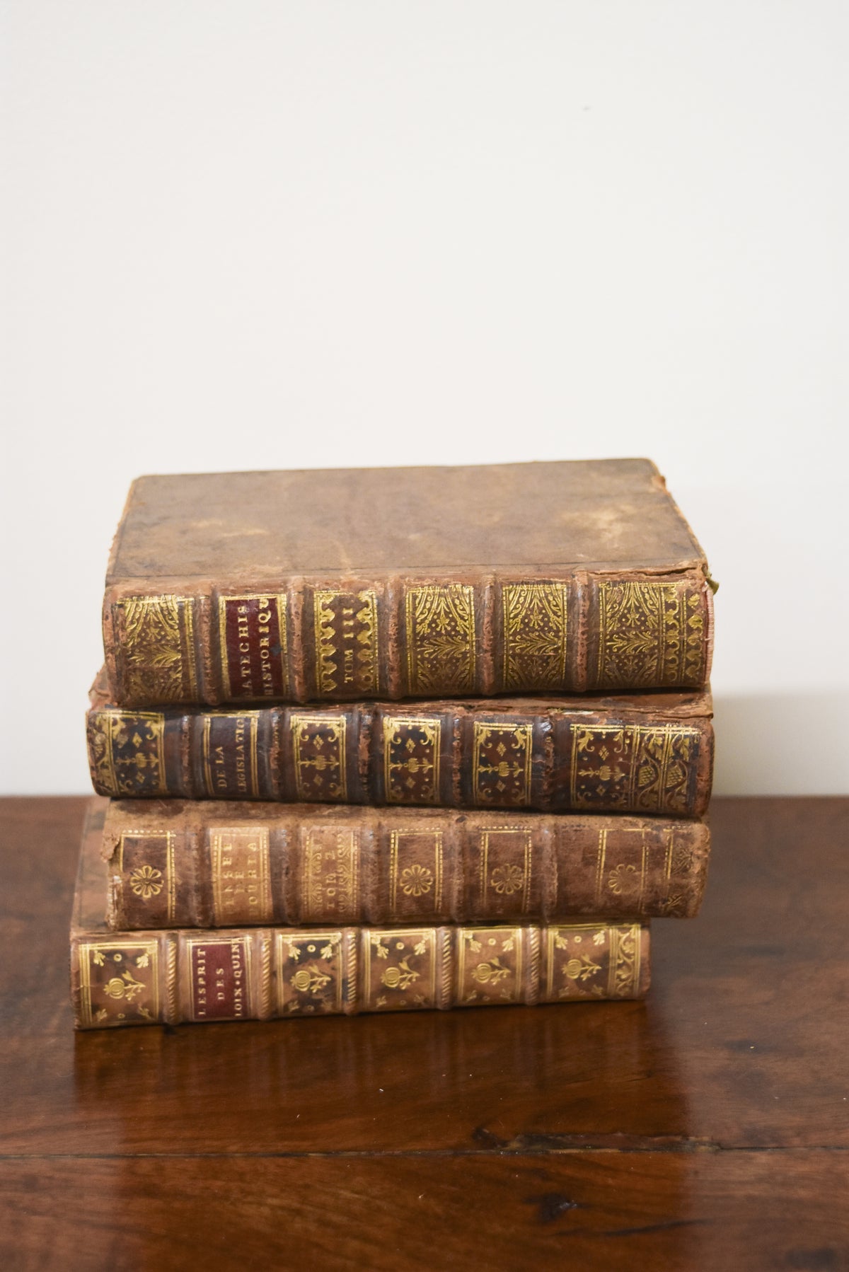Set of 4 Antique Leatherback Books with Red Accents